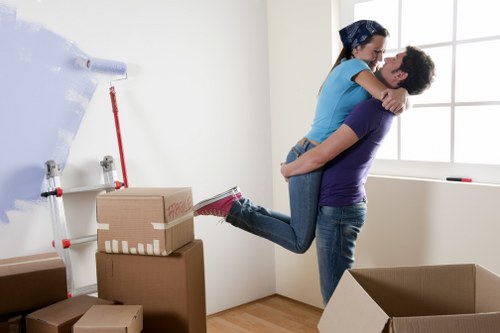 Staff organising labelled boxes and workstation items during an office move