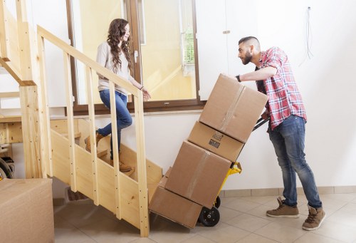 Household boxes and furniture being transported by a Borough moving van